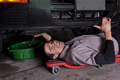Home mechanic working under a vehicle